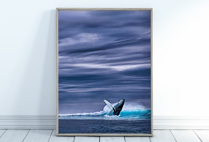 May include: Framed art print depicting a breaching whale in a turquoise wave. The whale's dark body contrasts with the white spray and the deep blue ocean. The sky is filled with dark, dramatic clouds, creating a moody seascape.