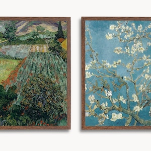 May include: Two framed paintings, one depicting a landscape with a field of green and red flowers, and the other a close-up of a white flowering tree against a blue sky.
