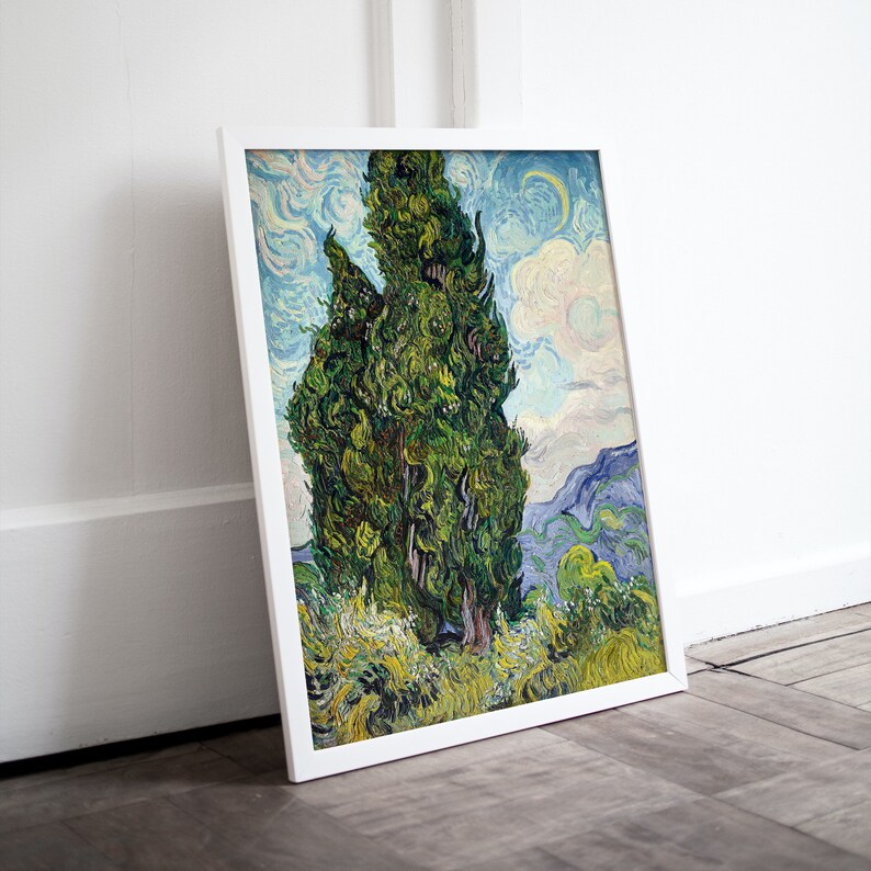 May include: A framed print of a painting by Vincent van Gogh depicting three tall, green cypress trees against a blue and white sky. The trees are painted in a swirling, expressive style, characteristic of van Gogh's work.
