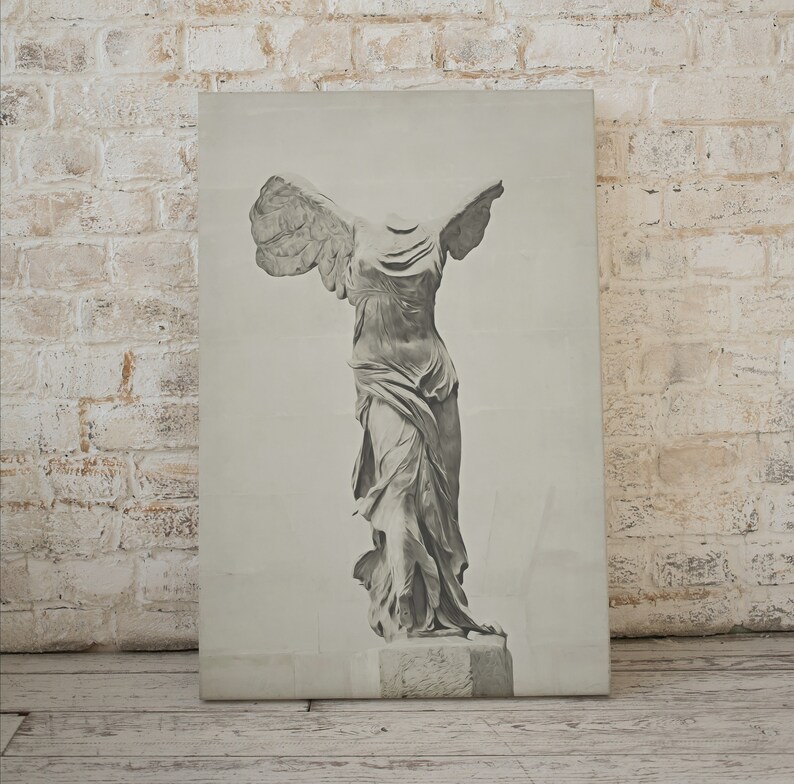 May include: A black and white print of the statue of the Winged Victory of Samothrace, also known as Nike of Samothrace. The statue is a Greek sculpture from the Hellenistic period, depicting the goddess Nike, the goddess of victory, landing on the prow of a ship.