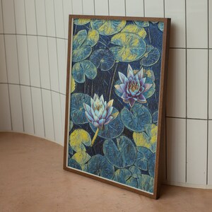 May include: A framed print of a watercolor painting featuring two water lilies with blue and purple petals against a background of blue and yellow water lily pads.