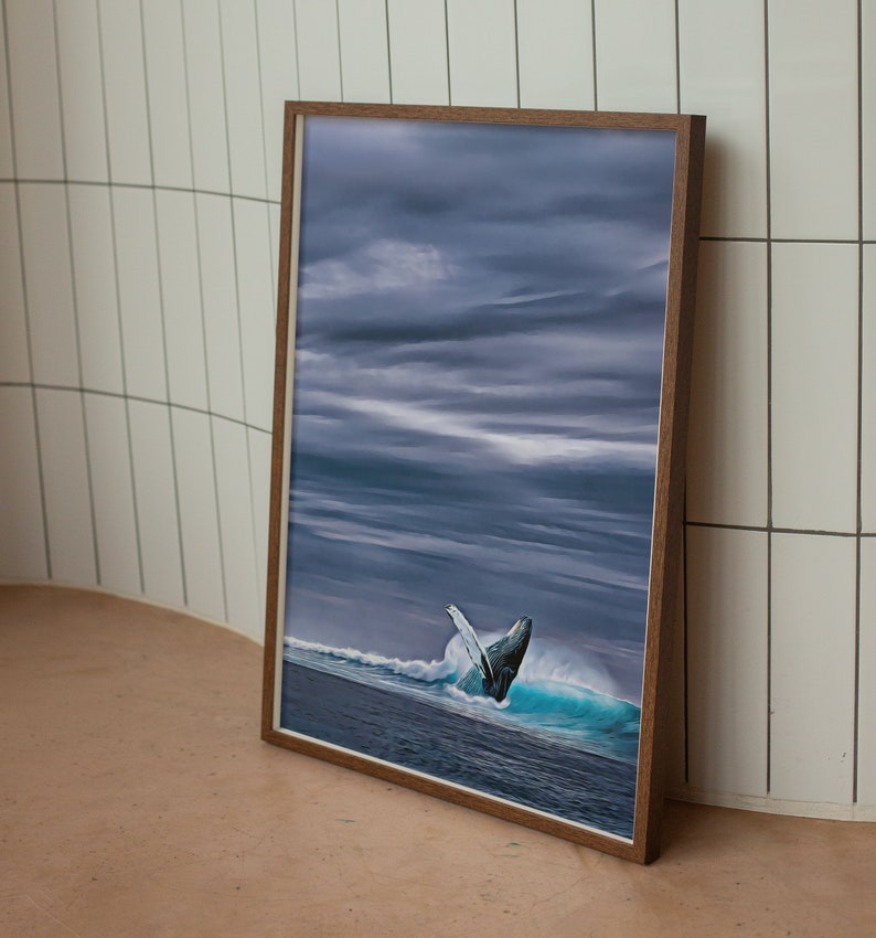 May include: A framed print featuring a breaching whale in a turbulent ocean scene under a dramatic, cloudy sky. The artwork is encased in a brown wooden frame, adding a touch of warmth to the cool tones of the ocean and sky.