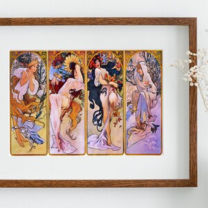 May include: A framed print of a vintage art nouveau illustration depicting four women representing the four seasons. Each woman is dressed in flowing robes and surrounded by flowers and foliage. The colours are vibrant and the artwork is detailed.