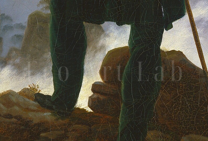 May include: Close-up of a person's legs wearing dark green pants and a long coat, standing on a rocky surface with a staff in their right hand. The background is a misty landscape with hills and trees.