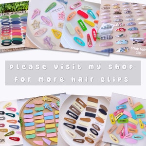 Puede incluir: Surtido de pinzas para el pelo de pl&aacute;stico de colores en varias formas, incluyendo estrellas, rect&aacute;ngulos y &oacute;valos. El texto "Por favor, visita mi tienda para m&aacute;s pinzas para el pelo" se muestra en el centro de la imagen.