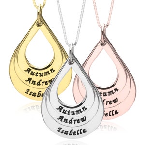 May include: Three teardrop-shaped pendants on delicate chains in gold, silver, and rose gold tones. Each pendant features three horizontal cutouts engraved with the names Autumn, Andrew, and Isabella in a black script font, suspended from thin chains.