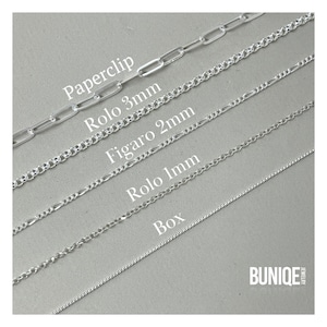 May include: Five different types of silver chains, including paperclip, rolo 3mm, figaro 2mm, rolo 1mm, and box chains. The chains are laid out in a row from top to bottom, with the paperclip chain at the top and the box chain at the bottom. The chains are labeled with their names and sizes. The image also includes the text "BUNIQUE JEWELRY".