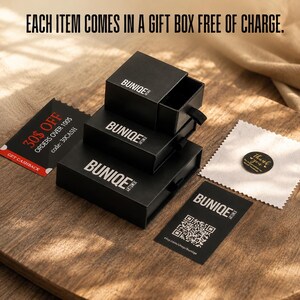 May include: Three stacked black square jewelry boxes with the white text BUNIQE JEWELRY. Includes a black card with a QR code, a black discount card with 30% OFF text, a small white square polishing cloth, and a round black thank you sticker.