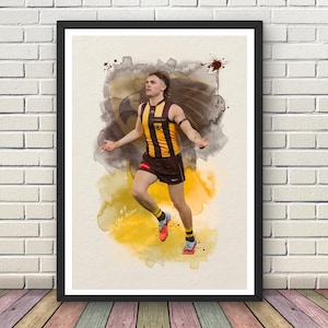 May include: A framed art print featuring a watercolor-style illustration of an Australian rules football player in a brown and gold striped jersey and shorts, number 5, with a hawk emblem background and the text #5 Nick Watson.