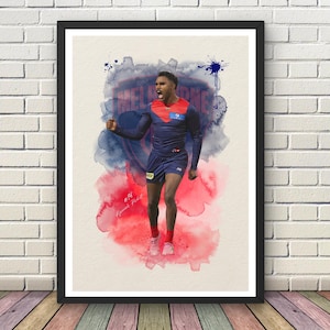 May include: A framed art print featuring a watercolour-style illustration of an Australian rules football player in a navy blue and red uniform with the number 36, celebrating with a shout against a backdrop of blue and red ink splashes.