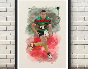 May include: A framed art print featuring a watercolor-style illustration of a rugby player in a red, green, and black jersey holding a white ball. The player is running, set against blended green and red paint splashes with the text #4 Jack Wighton.