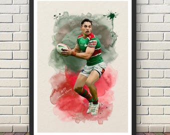 May include: A framed art print featuring a rugby player in a green and red jersey holding a ball. The player is depicted against a watercolor-style background of green and red splashes. The text #13 Cameron Murray is visible in the lower left.