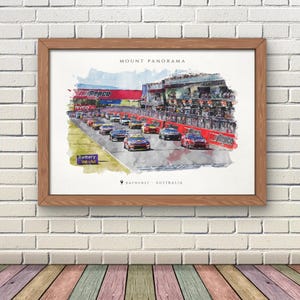 May include: A framed watercolor print depicting a race car event at Mount Panorama in Bathurst, Australia. The artwork features multiple colorful race cars on a track, a red grandstand with Repco signage, and text reading Mount Panorama.