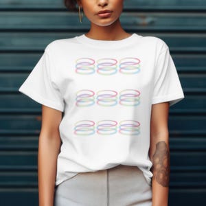 May include: White t-shirt with a graphic design of colorful, overlapping circles.