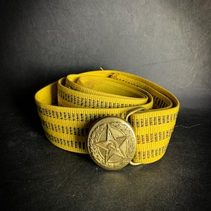 May include: A yellow woven belt with a gold metal buckle featuring a five-pointed star and a hammer and sickle.