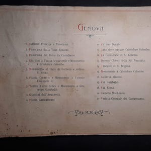 May include: A vintage, cream-colored, paper-bound book with a handwritten list of places to visit in Genoa, Italy. The list includes the "Stazione Principe" and "Palazzo Ducale".