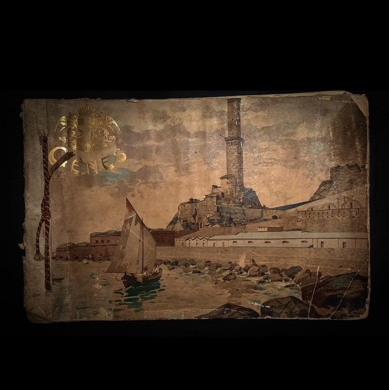 May include: A vintage postcard depicting a coastal scene with a tall tower, a sailboat, and a stone fortress. The postcard is faded and has a gold seal with the word "GENOA" printed on it.
