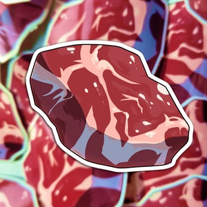 May include: A close-up of a red and white steak sticker. The sticker is shaped like a steak and has a white outline. The steak is surrounded by a background of blurred red and white steak stickers.