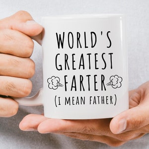 May include: White ceramic mug with black text that reads "World's Greatest Farter (I mean Father)" with a cartoon fart cloud on either side of the word "Farter".