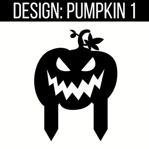 May include: Black silhouette of a pumpkin with a scary face and two stakes coming out of the bottom. The pumpkin has a stem with two leaves on top.