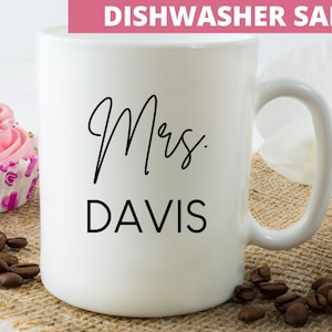May include: White ceramic mug with black text that reads "Mrs. DAVIS" and the words "Dishwasher Safe" in the top right corner.