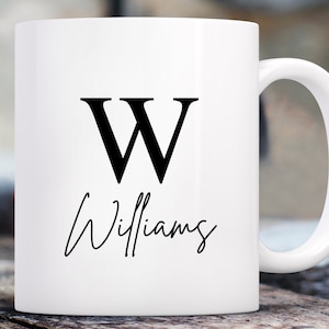 May include: White ceramic mug with a black letter W and the name Williams in cursive script.