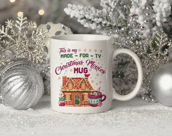 May include: White ceramic mug with a gingerbread house design and the text "This is my MADE - FOR - TV Christmas Movies MUG".