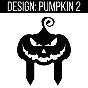 May include: Black silhouette of a jack-o'-lantern with a scary face and a stem. The pumpkin is on two stakes.