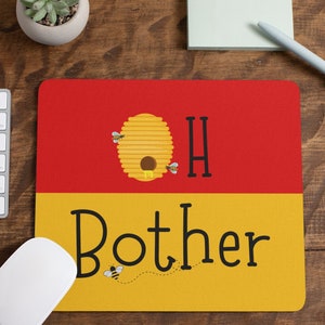 May include: A rectangular mousepad with a red and yellow color scheme. The top half is red, and the bottom half is yellow. The mousepad features a cartoon beehive with the words "OH Bother" and bee illustrations.
