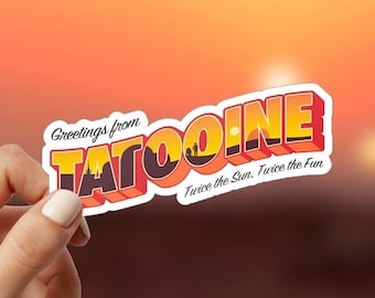 May include: A retro-style postcard with the text "Greetings from Tatooine. Twice the Sun. Twice the Fun." The postcard features a sunset scene with two suns and a silhouette of a desert landscape.