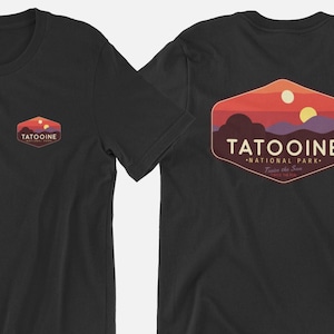 May include: Black t-shirt with a vintage-style Tatooine National Park logo on the back. The logo features a sunset scene with two suns and the text "Tatooine National Park - Two Suns in the Sky".