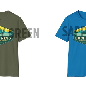 May include: Two t-shirts with a graphic design of a Loch Ness Monster in a national park. The t-shirt on the left is military green and the t-shirt on the right is sapphire blue.