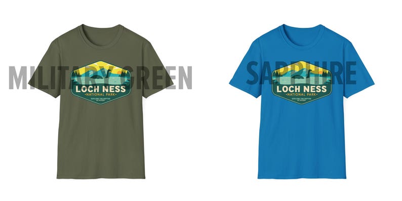 May include: Two t-shirts with a graphic design of a Loch Ness Monster in a national park. The t-shirt on the left is military green and the t-shirt on the right is sapphire blue.