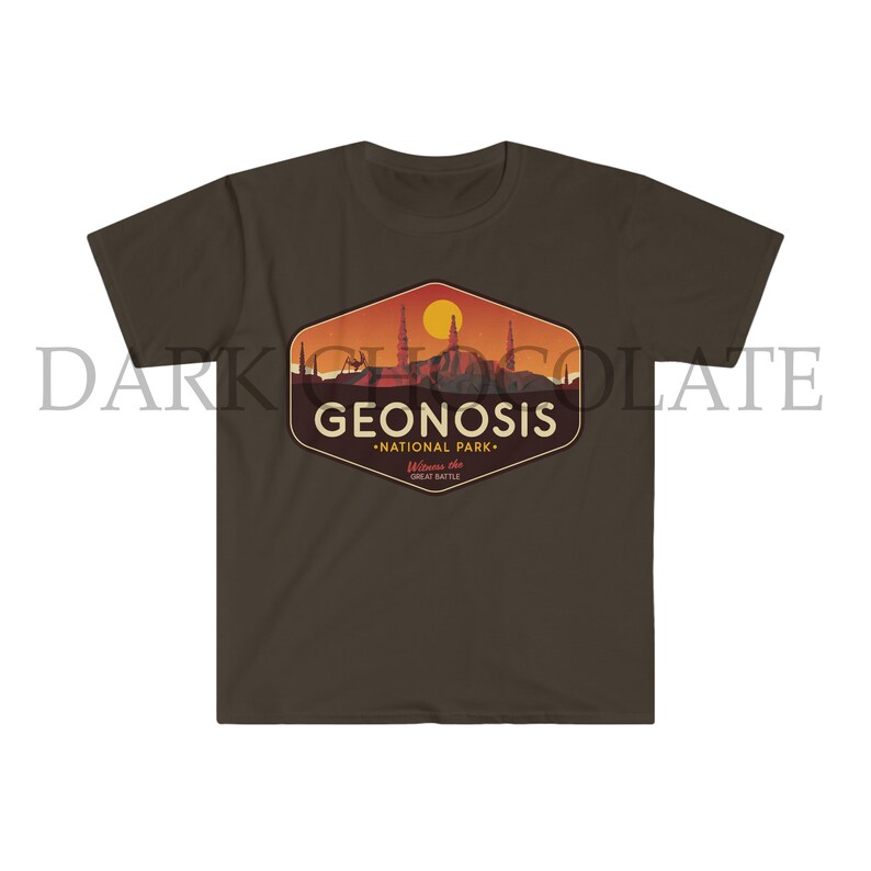 May include: A brown t-shirt featuring a vintage-style graphic of the fictional planet Geonosis from Star Wars. The graphic depicts a cityscape and the text "Geonosis - National Park - Welcome to the Great Battle".