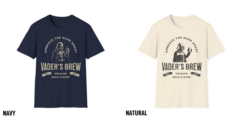 May include: A navy blue and a natural colored t-shirt with a graphic of Darth Vader holding a cup of coffee. The text on the shirt reads "Embrace the Dark Roast, Vader's Brew, Est. 1977, Unleash Bold Flavor".