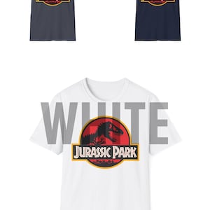 May include: Three t-shirts with the Jurassic Park logo. Two are navy blue and one is white. The logo features a dinosaur silhouette inside a red circle with the words "Jurassic Park" below.