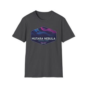 May include: Dark gray t-shirt featuring a graphic of the Mutara Nebula National Park. The design includes a stylized nebula in shades of blue, purple, and pink, with the park's name and location in white text. A short-sleeved, crew neck tee.