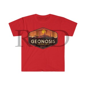 May include: Red t-shirt featuring a vintage-style logo for Geonosis National Park. The logo depicts a sunset over a cityscape with the text "Geonosis National Park" and "Welcome to the Great Battle".