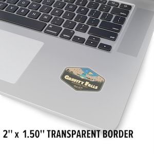 May include: A sticker featuring a retro-style illustration of a scenic landscape with a waterfall and the text "Gravity Falls National Park - Home of the Mystery Shack". The sticker is 2 inches by 1.5 inches and has a transparent border.