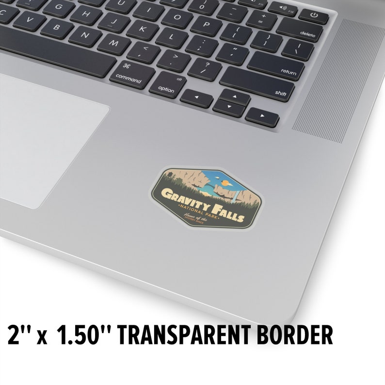 May include: A sticker featuring a retro-style illustration of a scenic landscape with a waterfall and the text "Gravity Falls National Park - Home of the Mystery Shack". The sticker is 2 inches by 1.5 inches and has a transparent border.
