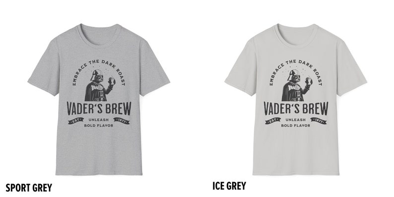 May include: Two gray t-shirts with a black and white graphic of Darth Vader holding a coffee cup. The text on the shirts reads "Embrace the Dark Roast, Vader's Brew, Est. 1977, Unleash Bold Flavor". The shirts are labeled "Sport Grey" and "Ice Grey".