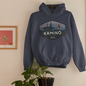 May include: A navy blue hoodie with a graphic of a blue and white planet with a space ship and the text "Kamino - watery planet.  Home to the Kaminoan Clones".