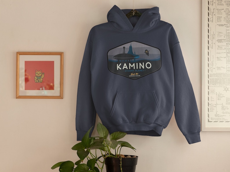 May include: A navy blue hoodie with a graphic of a blue and white planet with a space ship and the text "Kamino - watery planet.  Home to the Kaminoan Clones".