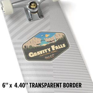 May include: A sticker featuring a retro-style illustration of a mountain range with a waterfall and a bridge. The text "Gravity Falls &bull; National Park. Home of the Mystery Shack" is printed on the sticker. The sticker is on a grey skateboard deck with a black and white striped pattern.