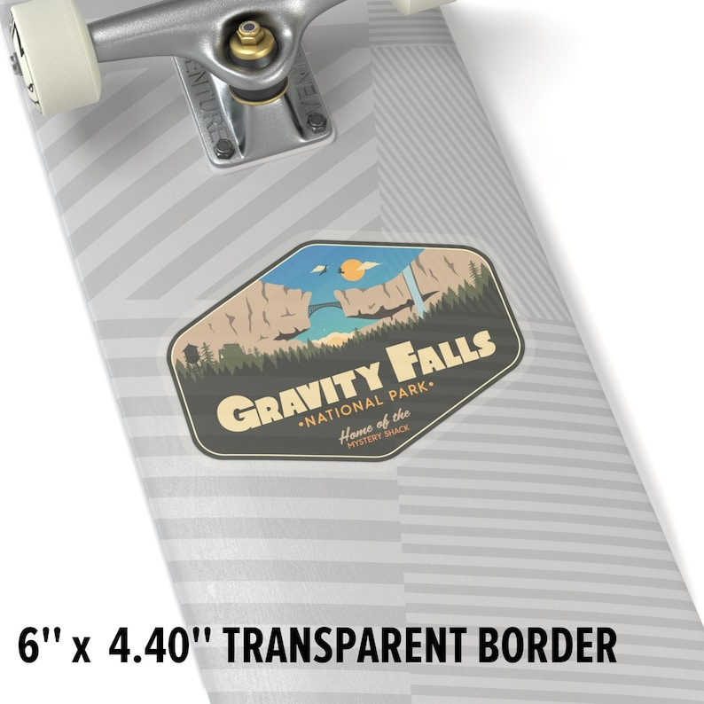 May include: A sticker featuring a retro-style illustration of a mountain range with a waterfall and a bridge. The text "Gravity Falls &bull; National Park. Home of the Mystery Shack" is printed on the sticker. The sticker is on a grey skateboard deck with a black and white striped pattern.