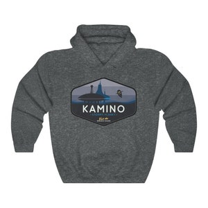 May include: A dark grey hooded sweatshirt with a graphic design of a blue and white cityscape with the text "KAMINO - STORMY PLANET -  Visit the ENDLESS OCEAN" in a blue and white hexagon.