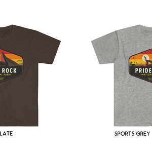 May include: Two t-shirts with a graphic design of a sunset scene with a mountain and the text "Pride Rock National Park" in a vintage style. The t-shirts are available in dark chocolate and sports grey.