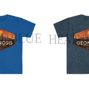 May include: Two t-shirts featuring a graphic design of a sunset landscape with the text "Geonosis National Park" in a vintage style. The t-shirt on the left is royal blue and the t-shirt on the right is heather navy.
