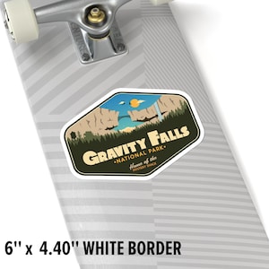 May include: A sticker featuring a green, yellow, and blue illustration of a mountain range, a bridge, and a waterfall. The text "GRAVITY FALLS &bull;NATIONAL PARK." is in white with a black outline. Below the text is "Home of the MYSTERY SHACK" in smaller white text.