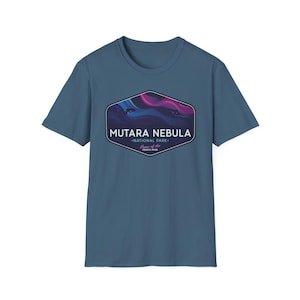 May include: A blue t-shirt featuring a graphic of the Mutara Nebula National Park. The graphic is a hexagon shape with the words "Mutara Nebula National Park" and "Home of the Genesis Span" in white text. The graphic has a purple and blue nebula design.